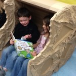 elementary students reading in chair