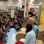 elementary students and teachers reading on chairs