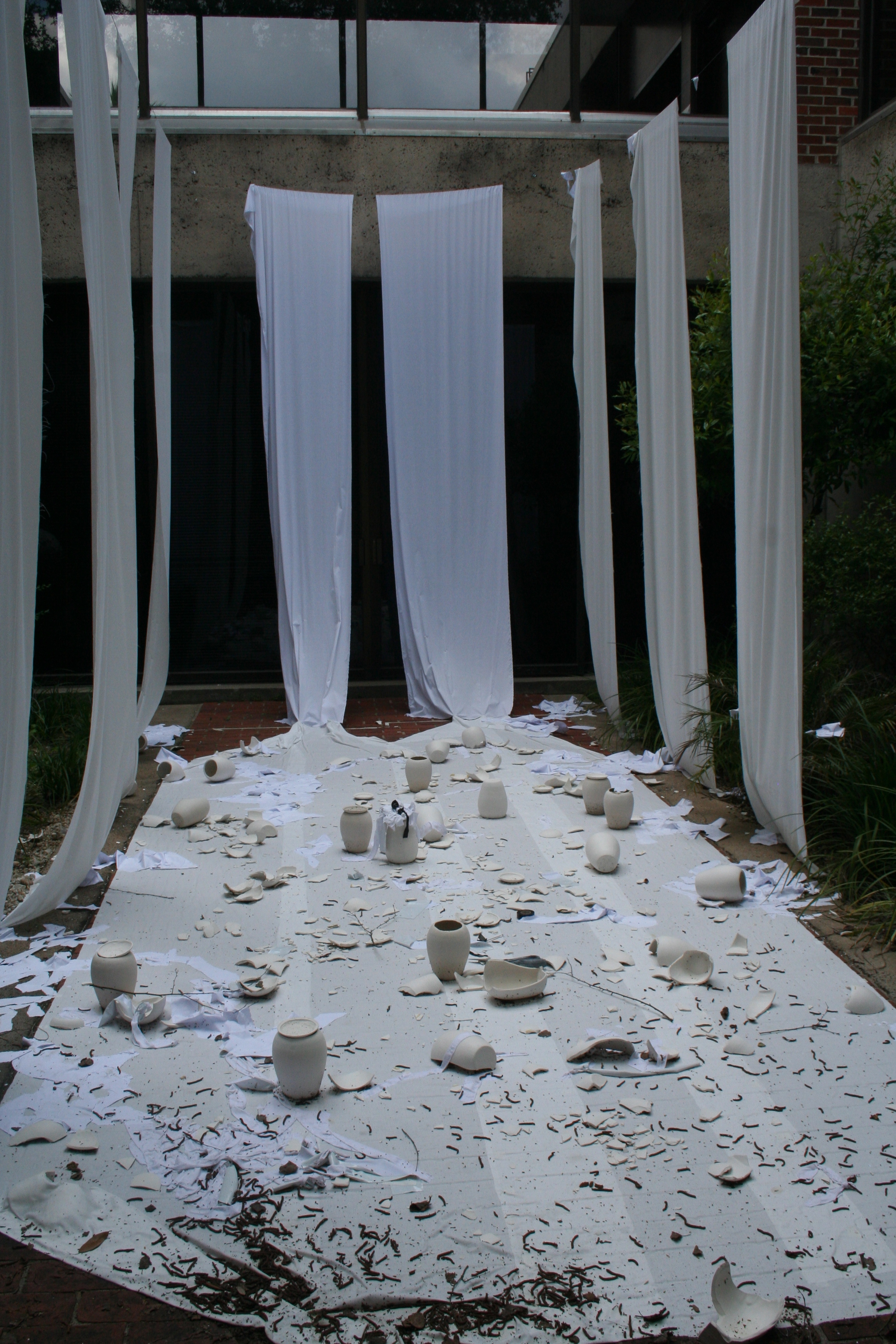 several broken pieces of pottery scattered on a white blanket