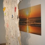 Paper Collage hanging in front of Image of a sunset