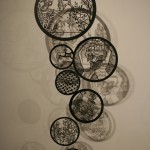 circular laser cut illustrations on a wall