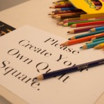 Color pencils on sign that says "Please Create Your Own Quilt Square."