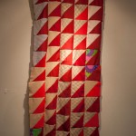 Photo of red and beige quilt with patterns