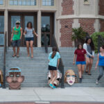 Students preparing for their demonstration with cardboard head