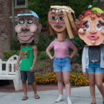 Angle shot of three students with cardboard heds