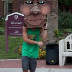 Male student with cardboard head dancing