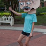 Female student with cardboard head dancing