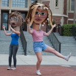 Female student with cardboard head dancing