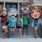 Students pose with cardboard heads in front of Westcott