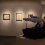 Angled shot of artworks and the Enterprise