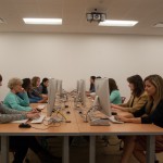 Frontal photo of students sitting at computers