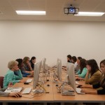 Frontal photo of students sitting at computers