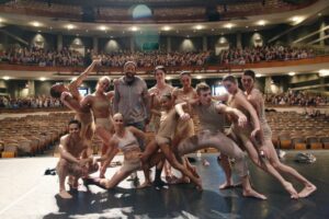 Dancers surround "American Crime" executive producer John Ridley, standing, third from left.