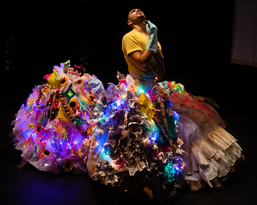 A dancer in a large light-up skirt. 