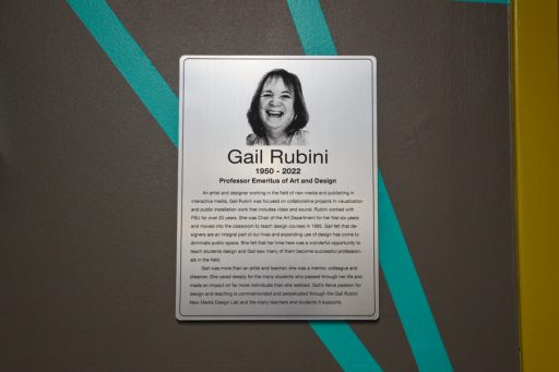 A plaque memorializes Gail Rubini. An etching of her with a joyful expression appears on the plaque. 