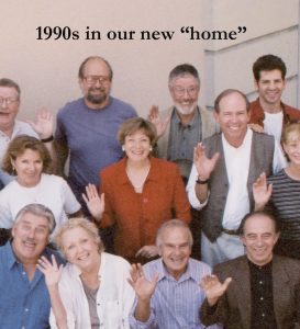 A group photos of people smiling and waving with text that reads "in our new 'home'"