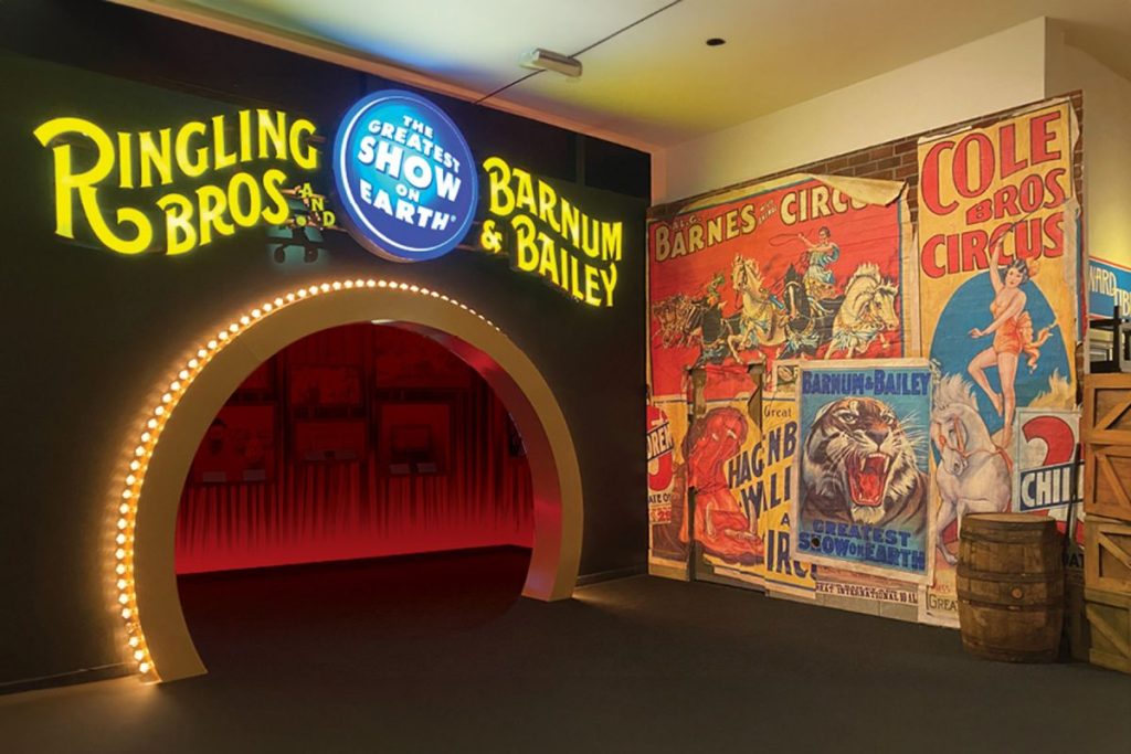 A tunnel is lit with LED lights, with yellow lights above reading "Ringling Bros Barnum & Bailey"