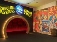 A tunnel is lit with LED lights, with yellow lights above reading "Ringling Bros Barnum & Bailey"