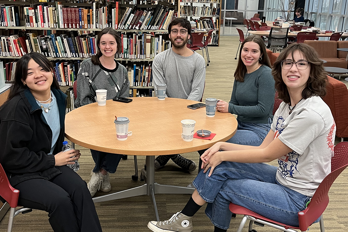 a group of students sitting around a table in a library
