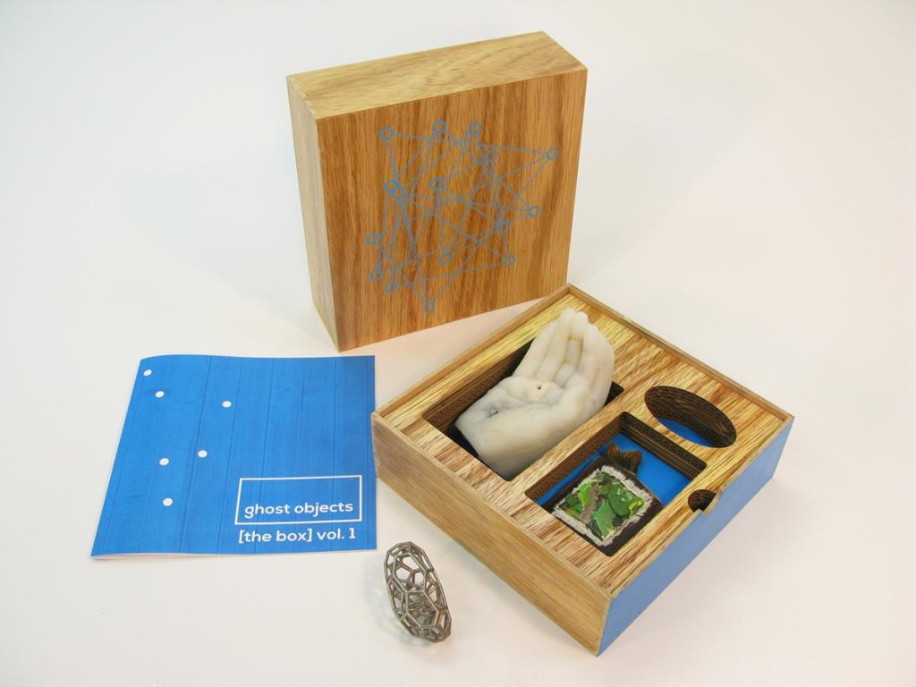 there is a small wooden box with a pair of shoes inside of it