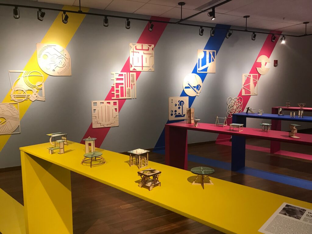 colorful tables are on display in an art gallery