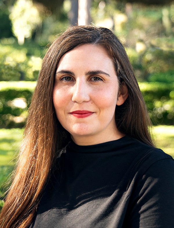 a woman with long brown hair wearing a black shirt