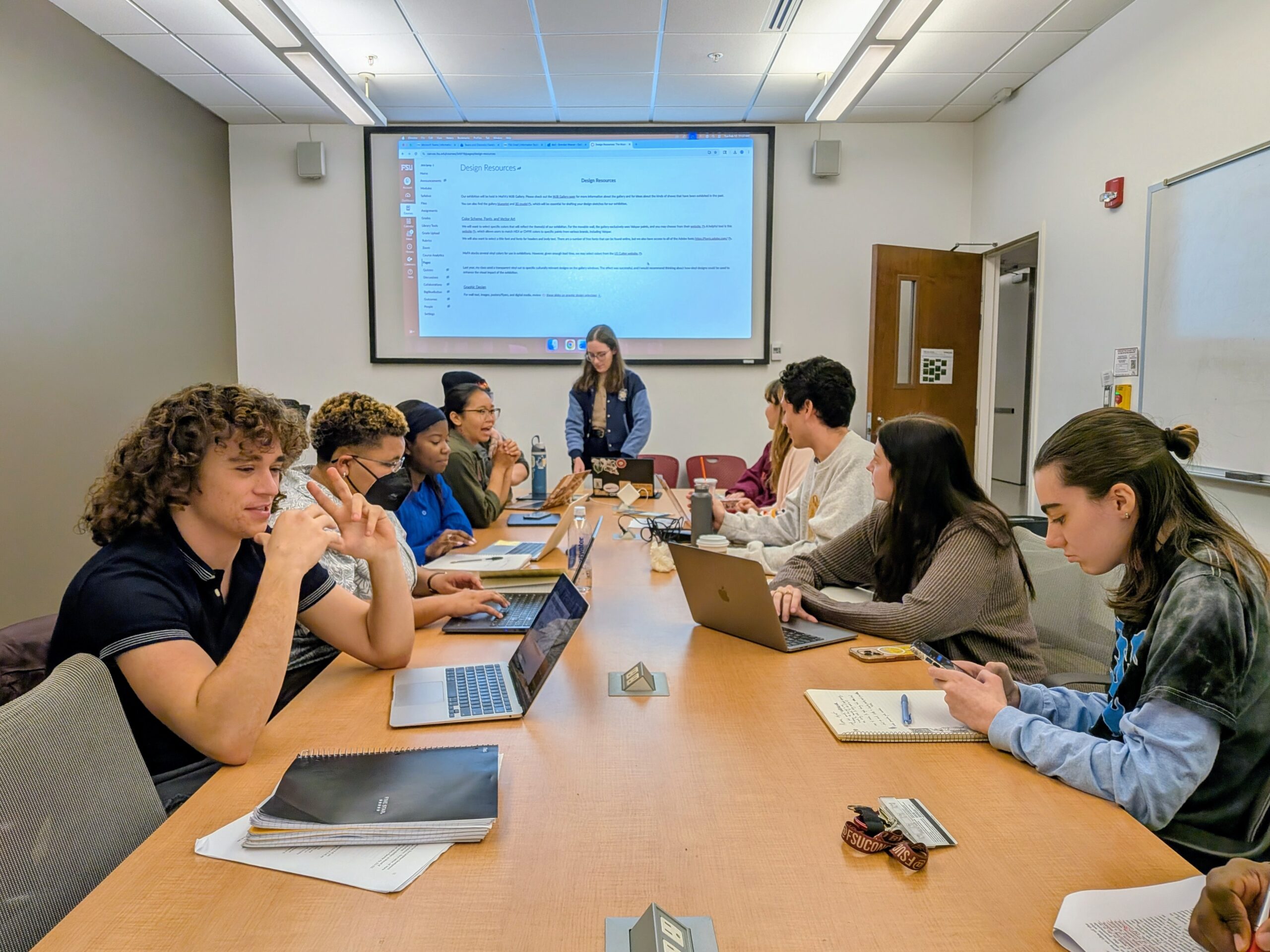 Students at a large table in a classroom setting
