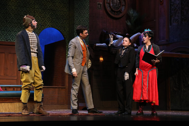four people on stage making an act